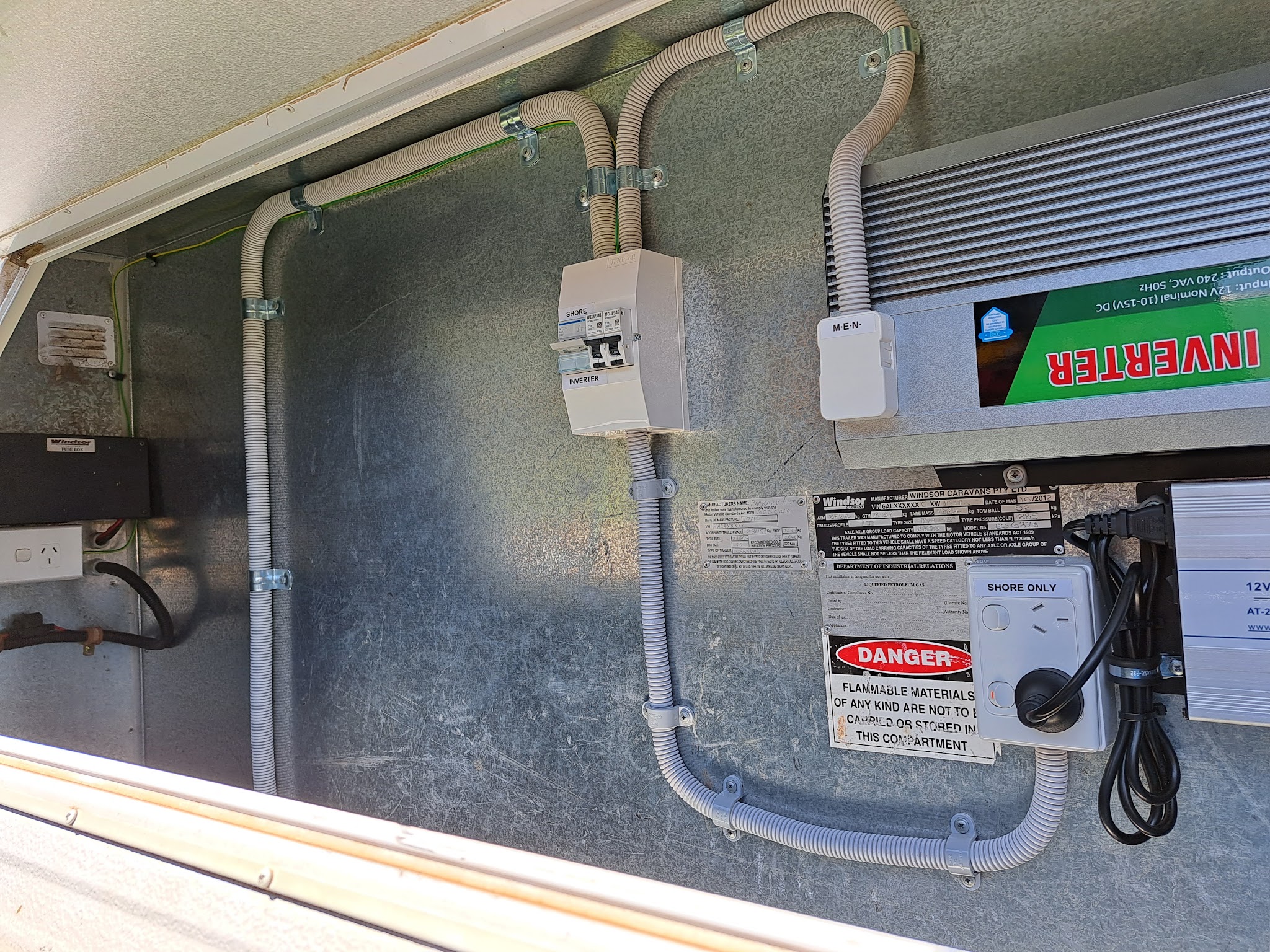 A caravan 240V compartment with the inverter, shore and inverter changeover breakers and the M-E-N box fitted