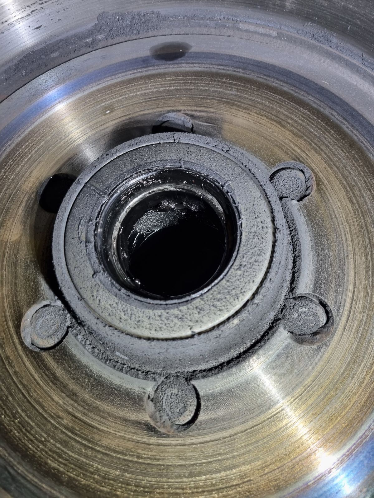 Close up inside a caravan wheel hub showing the bearing, seal and grease